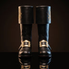 Pair, close together, buckles crossed: Pair of black leather Santa Claus boots with gold embroidered reindeer design on fold-over cuffs and engraved gold buckle straps
Pair, front-facing: Front view of black genuine leather Santa Claus boots showing gold thread reindeer embroidery and ornate gold buckle detail
Single boot, 3/4 profile: Single black leather Santa Claus boot with gold reindeer embroidery cuff and engraved buckle strap, side profile view