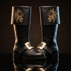 Pair, close together, buckles crossed: Pair of black leather Santa Claus boots with gold embroidered reindeer design on fold-over cuffs and engraved gold buckle straps
Pair, front-facing: Front view of black genuine leather Santa Claus boots showing gold thread reindeer embroidery and ornate gold buckle detail
Single boot, 3/4 profile: Single black leather Santa Claus boot with gold reindeer embroidery cuff and engraved buckle strap, side profile view