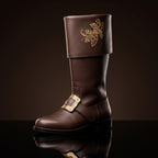 Pair, close together, buckles crossed: Pair of black leather Santa Claus boots with gold embroidered reindeer design on fold-over cuffs and engraved gold buckle straps
Pair, front-facing: Front view of black genuine leather Santa Claus boots showing gold thread reindeer embroidery and ornate gold buckle detail
Single boot, 3/4 profile: Single black leather Santa Claus boot with gold reindeer embroidery cuff and engraved buckle strap, side profile view